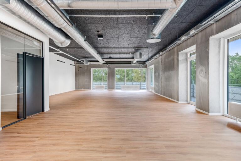 New, empty office unit with wooden floor, exposed services and large windows